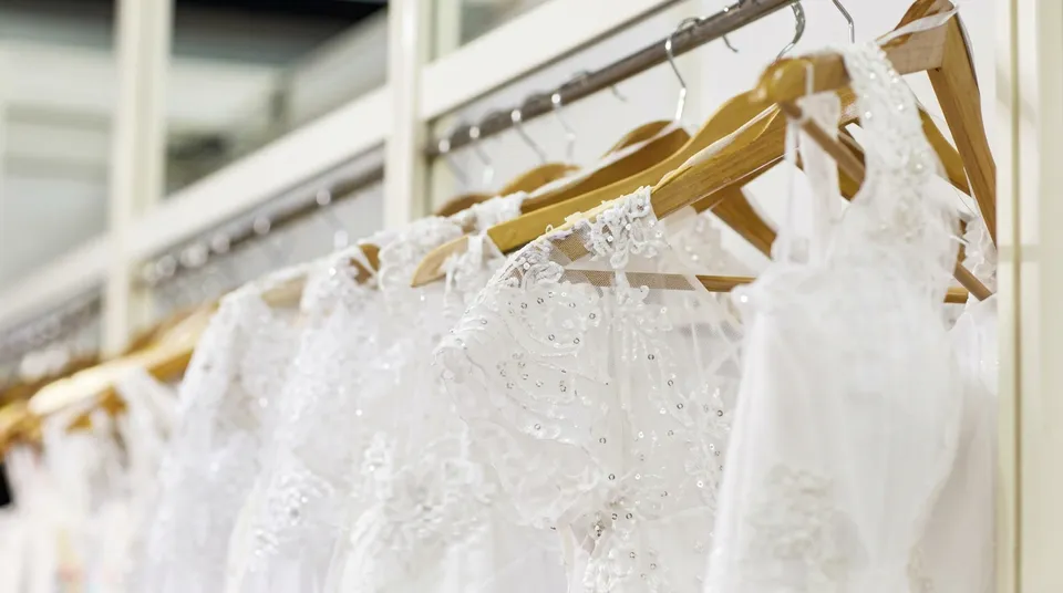 White lace wedding dresses on wooden hangers